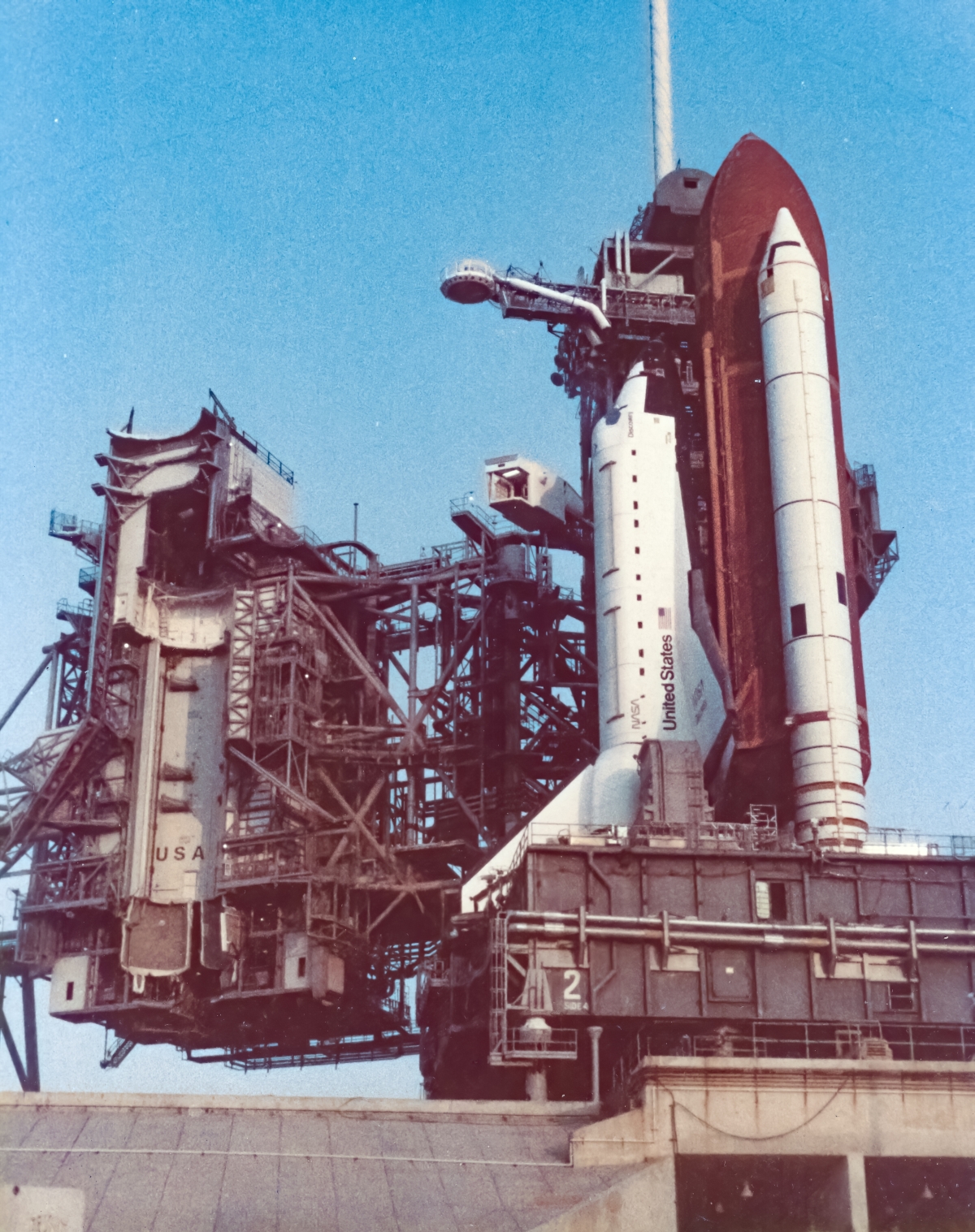 August 10, 1984, Space Shuttle Discovery, initial rollout to Launch Complex 39-A, Kennedy Space Center, Florida, prior to its first launch, viewed from the access road leading to the high-pressure gas facility on the east side of the pad. To this day, I still marvel at my incredible good luck in getting this shot. Photograph of a lifetime.